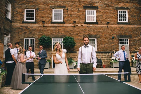 Table Tennis Wedding , Ping Pong Table at Wedding, Bride & Groom Playing Table Tennis. The wedding of designer Hannah Stoney to Steven Shuttlewood. Hannah is the owner of Yellowstone Art Boutique store in Staffordshire and designed all her own stationery!