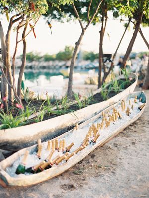 Canoe bar! Have done this for my son's 21st birthday with different brands of beer mixed in. Called it the "canoeler". Was a huge hit!