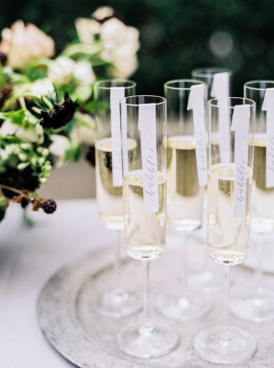Modern Champagne Flutes with Calligraphy Signs | Sarah Carpenter Photography | Organic Black and White Wedding