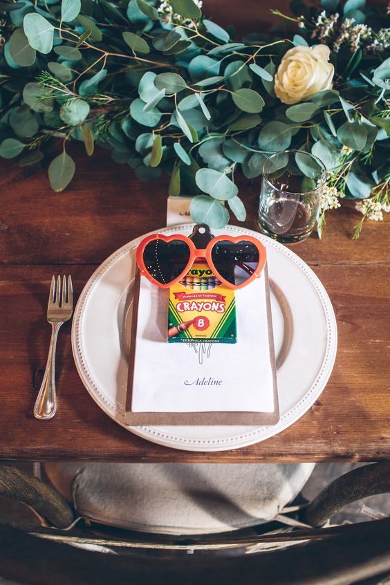 Keep it simple on the kids table. A pack of crayons, a clipboard of fresh paper, and pair of cute shades are all you need to keep little ones content throughout the event.