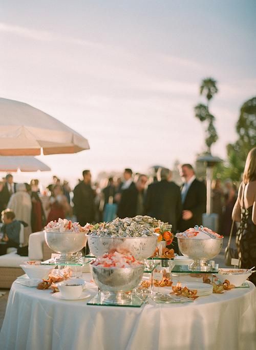 A glorious raw bar displayed on ice in elegant footed bowls | Brides.com
