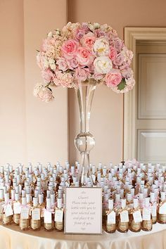 Use escort cards that double as favors, like these mini champagne bottles.