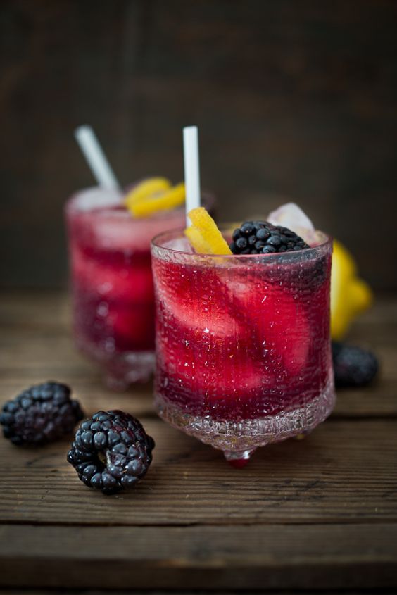 A refreshing summer drink, The Blackberry Bramble, featuring fresh muddled blackberries, gin, lemon juice and soda or ginger beer | www.feastingathome.com